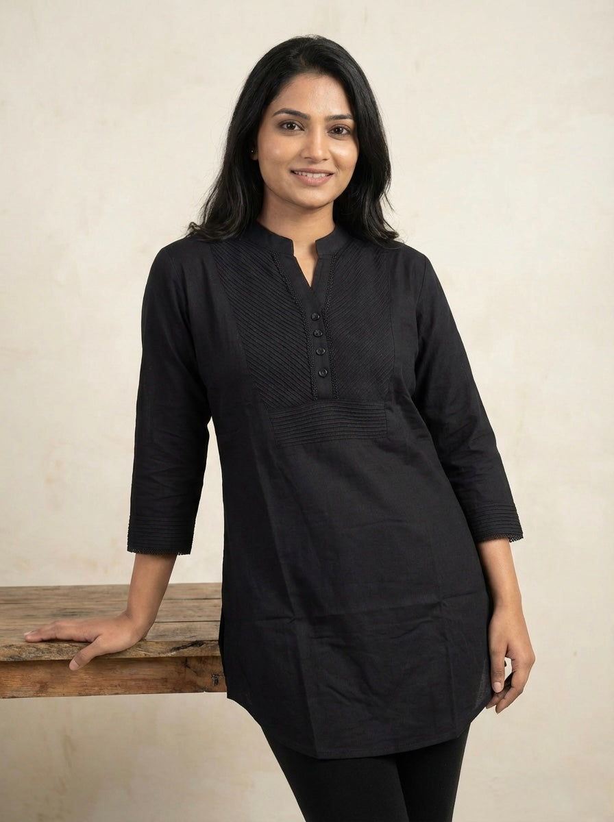 Women's black slub cotton short kurti top with pintuck neck design and 3/4 sleeves.
